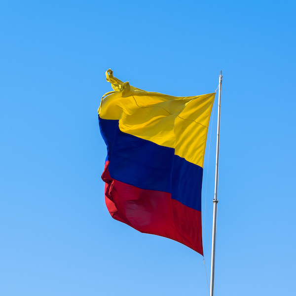A Colombian flag is streaming in the wind.
